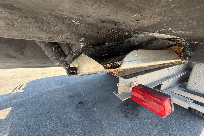 Slide: The Image of 1994 Grady-White Sailfish 272 boat underside on trailer, showing hull and trailer light. - 3