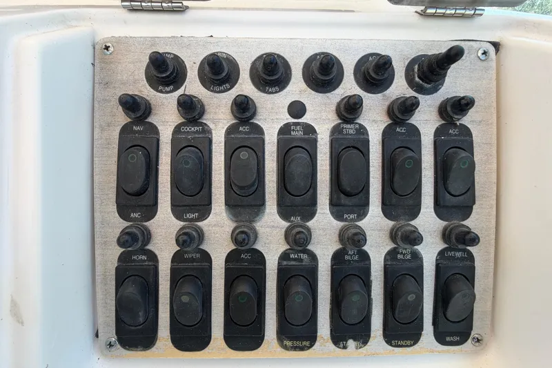 Slide: The Image of Control panel of a 1994 Grady-White Sailfish 272 boat with various switches. - 32