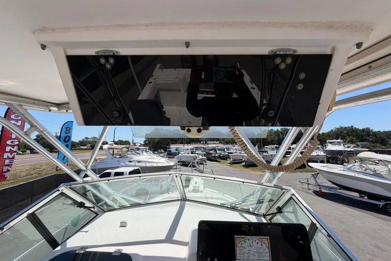 Slide: The Image of 1994 Grady-White Sailfish 272 boat dashboard view at marina with multiple boats. - 34
