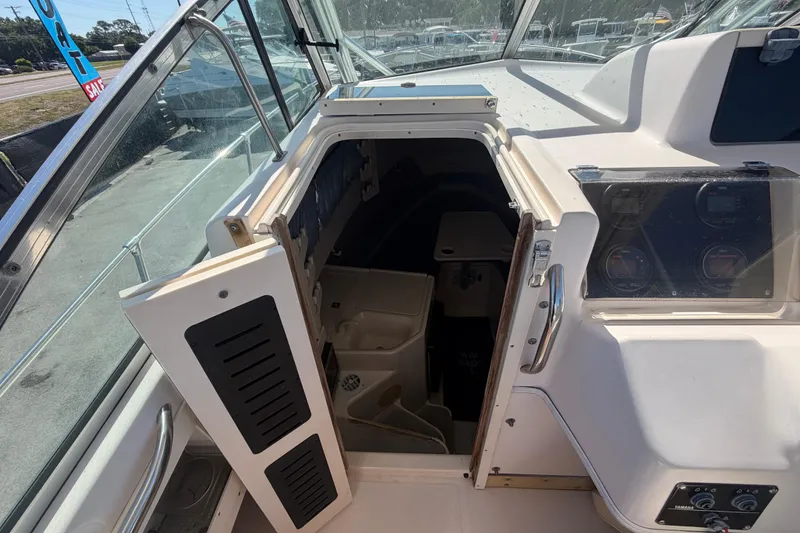 Slide: The Image of 1994 Grady-White Sailfish 272 cabin entrance with dashboard and controls visible. - 37