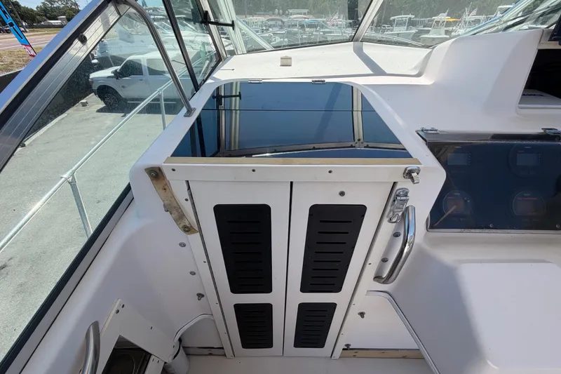 Slide: The Image of 1994 Grady-White Sailfish 272 boat cockpit with control panel and windshield view. - 38