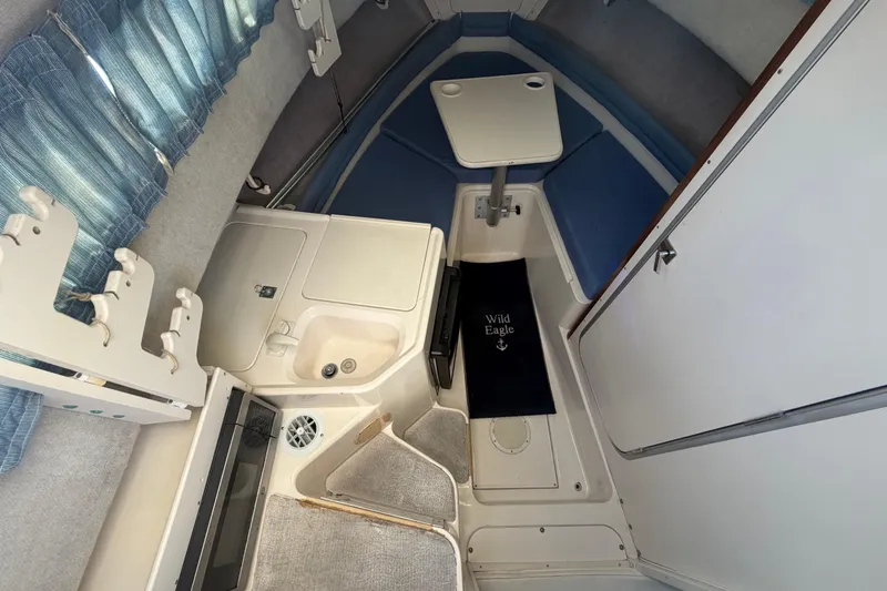 Slide: The Image of Interior of 1994 Grady-White Sailfish 272 boat with seating, table, and compact sink area. - 40