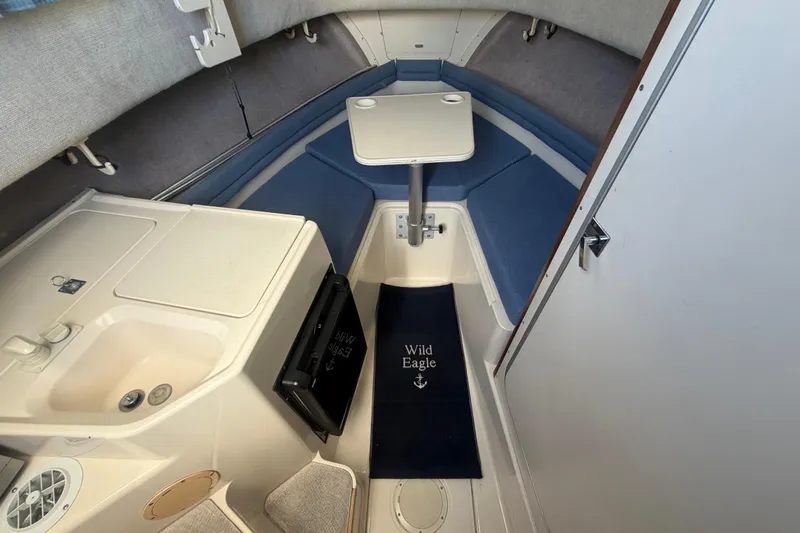 Slide: The Image of 1994 Grady-White Sailfish 272 cabin interior with sink, table, and seating. - 41