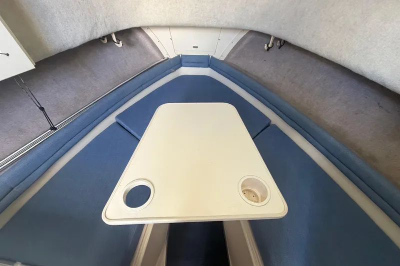 Slide: The Image of 1994 Grady-White Sailfish 272 cabin interior with table and blue seating. - 42