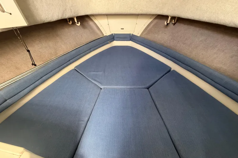 Slide: The Image of Interior cabin of 1994 Grady-White Sailfish 272 with blue cushions. - 43