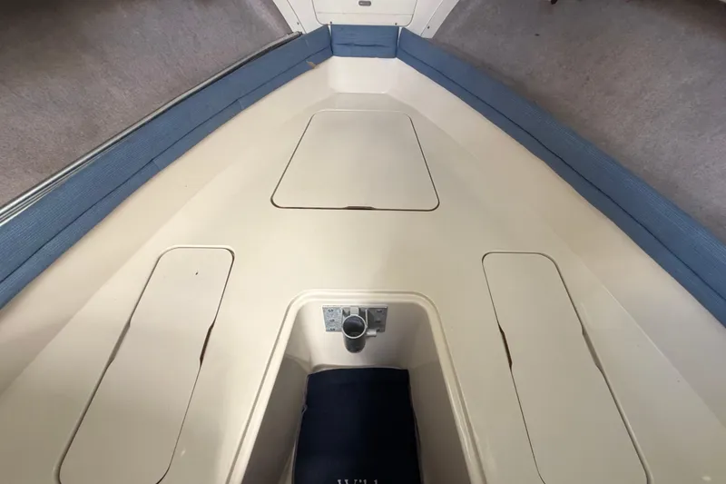 Slide: The Image of 1994 Grady-White Sailfish 272 boat interior with storage compartments and blue trim. - 44