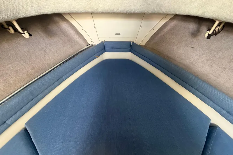 Slide: The Image of Interior cabin of 1994 Grady-White Sailfish 272 with blue cushions and beige walls. - 46