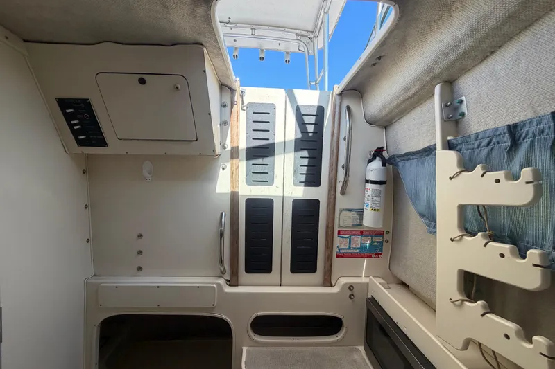 Slide: The Image of Interior cabin of 1994 Grady-White Sailfish 272 boat with storage and fire extinguisher. - 51