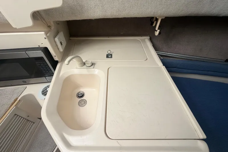 Slide: The Image of 1994 Grady-White Sailfish 272 cabin sink and countertop with microwave. - 54