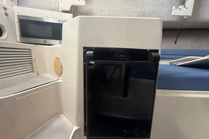 Slide: The Image of Interior of 1994 Grady-White Sailfish 272 boat with microwave and mini fridge. - 58