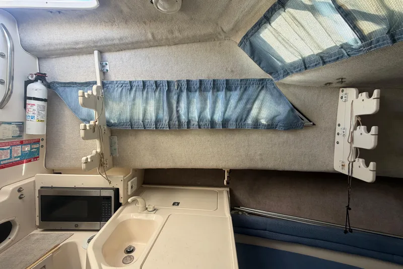 Slide: The Image of Interior of 1994 Grady-White Sailfish 272 boat with kitchenette and storage features. - 60
