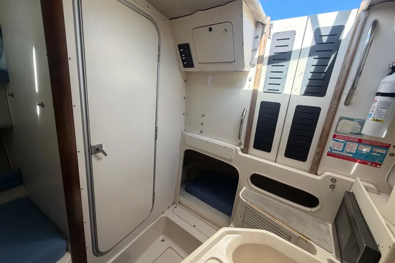 Slide: The Image of 1994 Grady-White Sailfish 272 cabin interior with storage, seating, and safety equipment. - 62