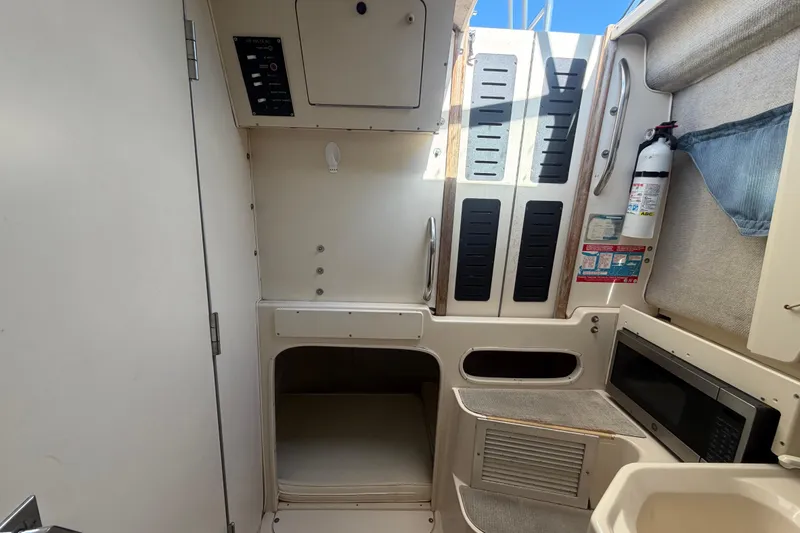 Slide: The Image of Interior of 1994 Grady-White Sailfish 272 boat with microwave and storage compartments. - 67