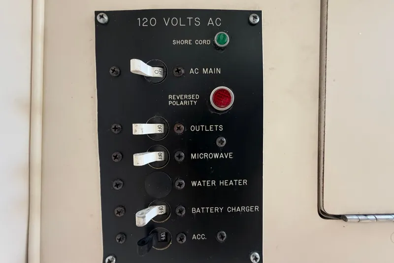 Slide: The Image of Electrical panel on 1994 Grady-White Sailfish 272 boat, showing 120 volts AC controls. - 69