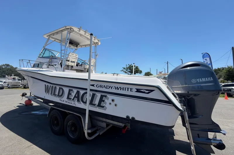 Slide: The Image of 1994 Grady-White Sailfish 272 boat on trailer with Yamaha engine, labeled "Wild Eagle." - 7