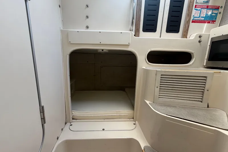 Slide: The Image of 1994 Grady-White Sailfish 272 cabin interior with storage compartments and seating area. - 70