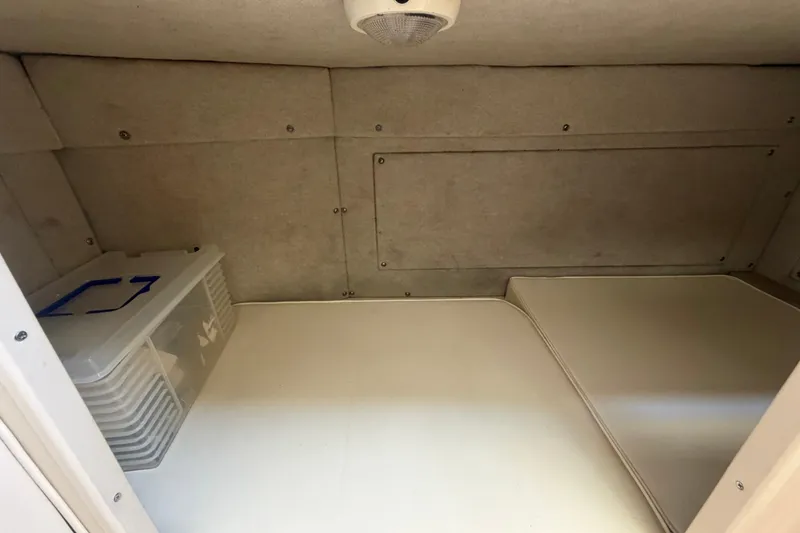 Slide: The Image of Interior cabin of 1994 Grady-White Sailfish 272 boat, featuring storage and seating area. - 71