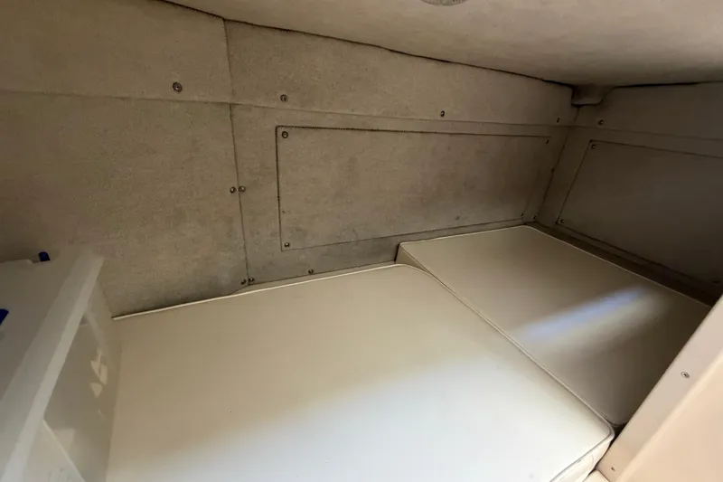 Slide: The Image of Interior cabin of 1994 Grady-White Sailfish 272 boat, featuring cushioned seating. - 72