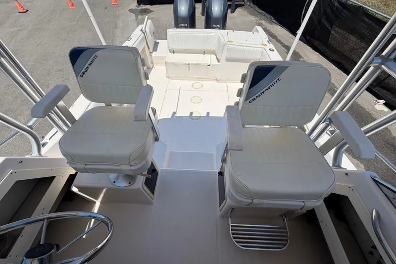Slide: The Image of 1994 Grady-White Sailfish 272 boat interior with dual captain chairs and steering wheel. - 75