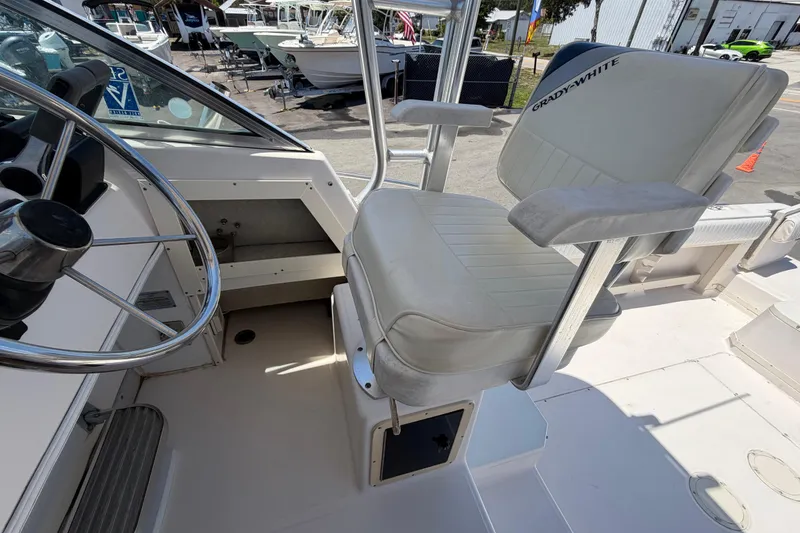 Slide: The Image of Captain's chair on 1994 Grady-White Sailfish 272 boat, featuring steering wheel and cockpit view. - 76