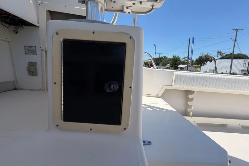 Slide: The Image of 1994 Grady-White Sailfish 272 boat interior with storage compartment and seating area. - 78