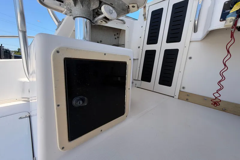 Slide: The Image of 1994 Grady-White Sailfish 272 boat interior, featuring helm console and storage compartments. - 80