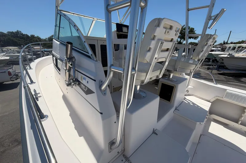 Slide: The Image of 1994 Grady-White Sailfish 272 boat interior with seating and railing, docked outdoors. - 82