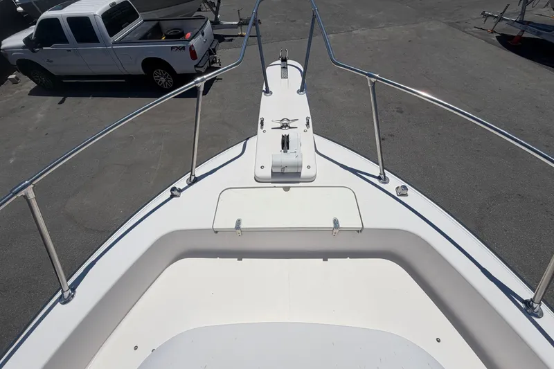 Slide: The Image of Bow view of 1994 Grady-White Sailfish 272 boat, parked near a white pickup truck. - 85