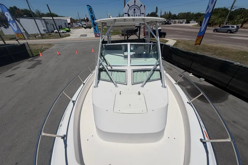 Slide: The Image of 1994 Grady-White Sailfish 272 boat on display at a dealership, viewed from the bow. - 90