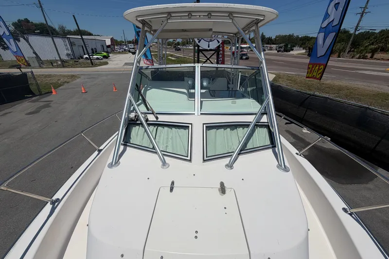 Slide: The Image of 1994 Grady-White Sailfish 272 boat, docked, showcasing its sturdy design and spacious deck. - 91