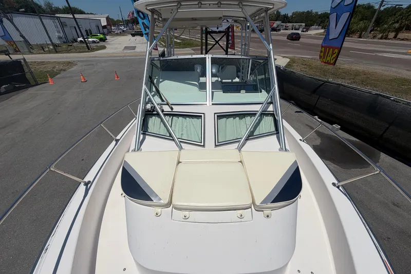 Slide: The Image of 1994 Grady-White Sailfish 272 boat, docked, showcasing bow seating and windshield. - 92