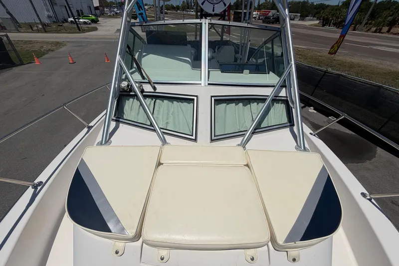Slide: The Image of 1994 Grady-White Sailfish 272 boat deck with cushioned seating and windshield view. - 93