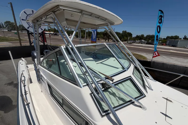 Slide: The Image of 1994 Grady-White Sailfish 272 boat with T-top and windshield, parked outdoors. - 94