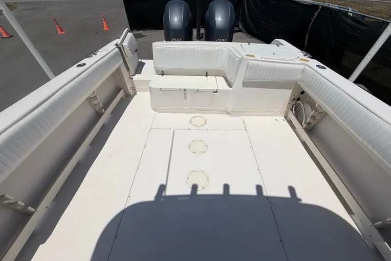 Slide: The Image of 1994 Grady-White Sailfish 272 boat deck with seating and twin engines. - 98