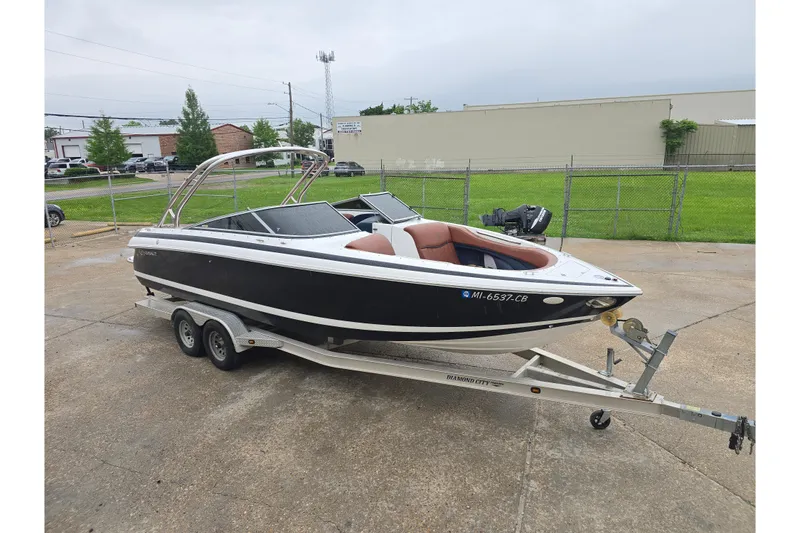 The Image of 2003 Cobalt 262 boat on trailer, black exterior, parked outdoors. - 0
