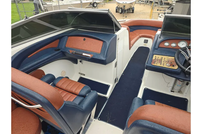 Slide: The Image of Interior of a 2003 Cobalt 262 boat with blue and brown seating. - 11