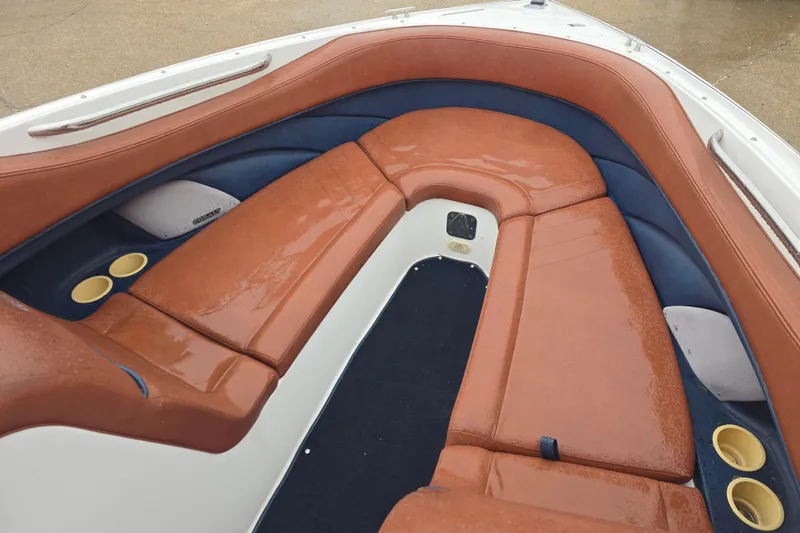 Slide: The Image of Interior of a 2003 Cobalt 262 boat with brown and blue seating. - 12