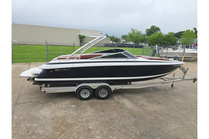 Slide: The Image of 2003 Cobalt 262 boat on trailer, parked outdoors, side view. - 3
