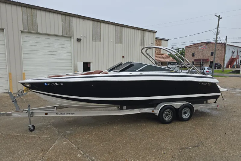 Slide: The Image of 2003 Cobalt 262 boat on trailer, parked outside industrial building. - 5