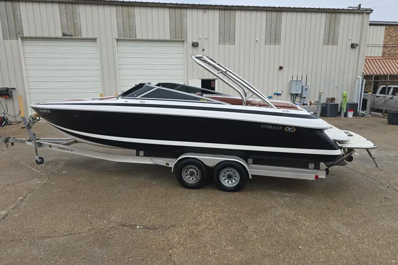 Slide: The Image of 2003 Cobalt 262 boat on trailer, parked outside industrial building. - 7