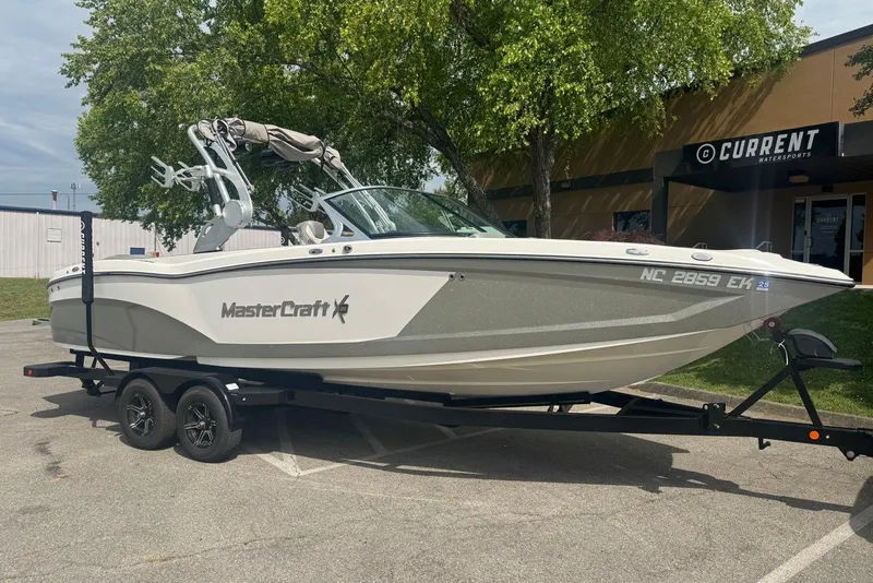 Slide: The Image of 2017 MasterCraft X26 boat on trailer outside Current Watersports building. - 1