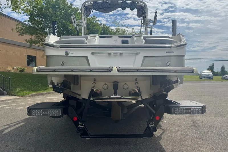 Slide: The Image of Rear view of a 2017 MasterCraft X26 boat on a trailer in a parking lot. - 4