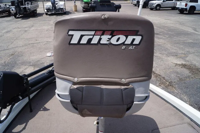 Slide: The Image of 2004 Triton Tr-196 DC boat seat with logo in a parking lot. - 10