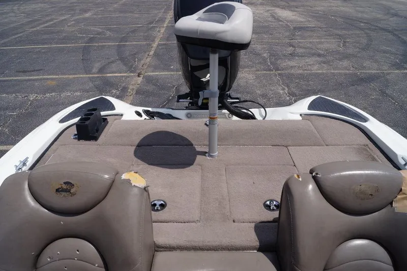 Slide: The Image of 2004 Triton Tr-196 DC boat interior with worn seats and fishing platform. - 15