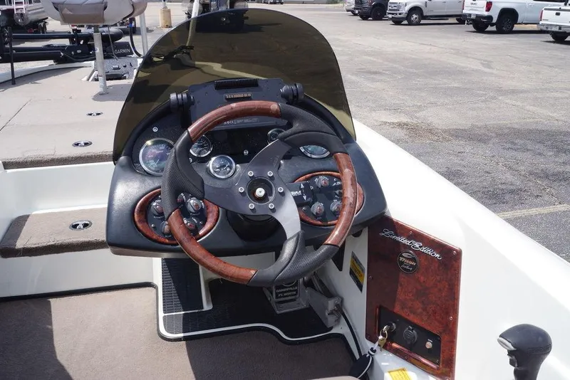 Slide: The Image of 2004 Triton Tr-196 DC boat dashboard with wood-accented steering wheel and instrument panel. - 18