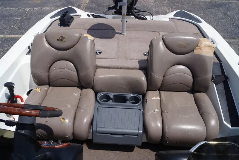 Slide: The Image of 2004 Triton Tr-196 DC boat interior with worn leather seats and central console. - 20
