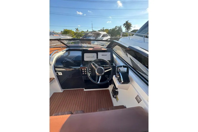 Slide: The Image of 2025 NX Boats NX290 Exclusive cockpit with Garmin navigation and Mercury controls. - 18