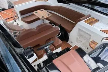 Slide: The Image of 2025 NX Boats NX290 Exclusive interior with luxurious seating and modern design. - 2