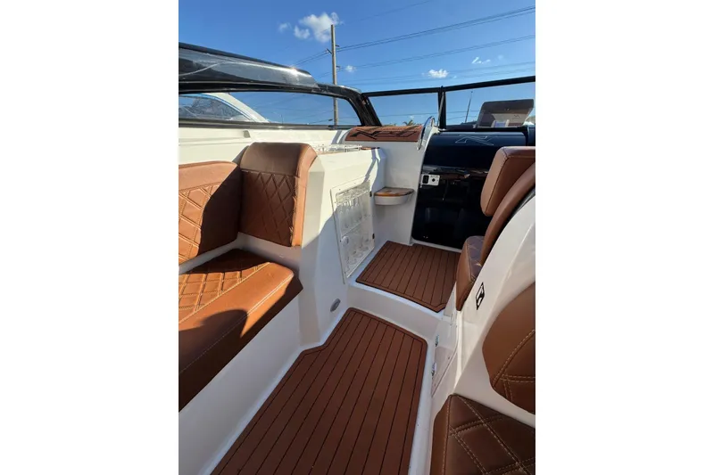 Slide: The Image of Luxurious interior of 2025 NX Boats NX290 Exclusive with brown leather seating and sleek design. - 21