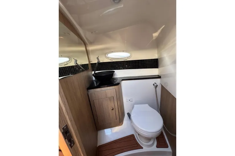 Slide: The Image of Luxurious bathroom interior of 2025 NX Boats NX290 Exclusive, featuring modern fixtures and wood accents. - 26